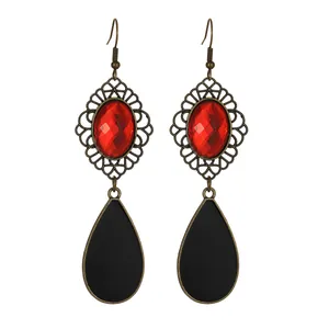 Detailed close-up of retro water drop earrings with red gemstone and black fringe
