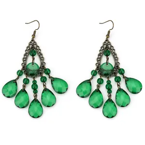 Detail of vintage emerald green waterdrop tassel earrings with filigree bronze base