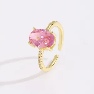 Detail of 18K gold adjustable ring featuring a large oval pink zircon in four-prong setting