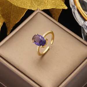 Macro detail of gold adjustable ring with oval purple gemstone and zircon accents