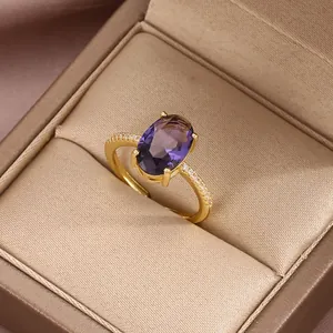 Macro detail of a vintage gold ring with a large oval purple gemstone in a jewelry box