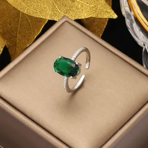 Detail of silver ring with oval emerald gemstone and micro-pave cubic zirconia accents