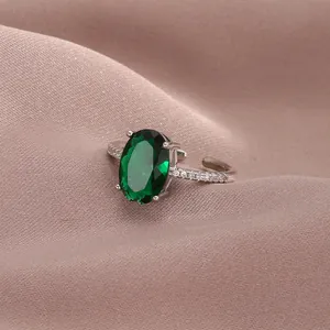 Detail shot of vintage silver ring with oval green stone and zircon side accents