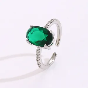 Macro detail of silver adjustable ring featuring oval green gemstone and pavé accents