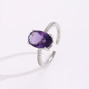 Detail shot of vintage silver ring with oval purple gemstone and pavé zircon accents