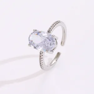 Detail of silver adjustable ring featuring an oval-cut cubic zirconia and pave band
