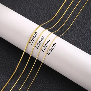 Gold titanium snake chains in four widths 0.9mm to 2.0mm displayed on a white stand