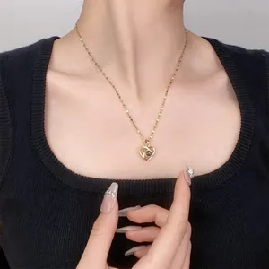 Golden heart projection necklace with 100 languages I Love You on female model neck