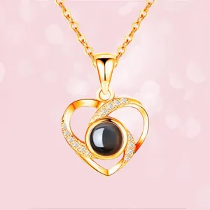 Golden heart projection necklace with I Love You in 100 languages and sparkling zircons