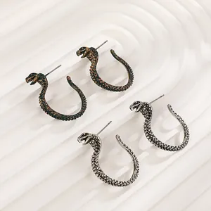 Detailed cobra earrings in antique bronze and silver finishes with scale textures