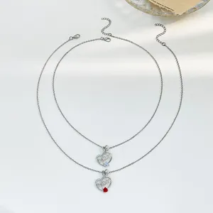 Detail of silver heart necklaces with Mom lettering and colorful crystal heart charms