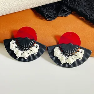Retro style acrylic fan earrings with red studs and white relief flowers on black base