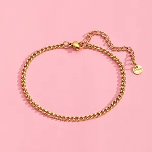 Detail of gold Cuban chain bracelet with lobster clasp and S.steel hallmark tag
