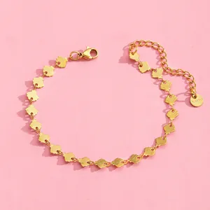 Detail of gold stainless steel scallop shell bracelet with lobster clasp and tag