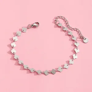 Macro detail of stainless steel shell-link bracelet with lobster clasp and extension chain