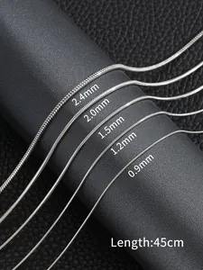 Macro shot of silver snake chains in widths from 0.9mm to 2.4mm on a black display