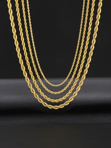 Close-up of four assorted thicknesses of golden stainless steel rope chains on black leather