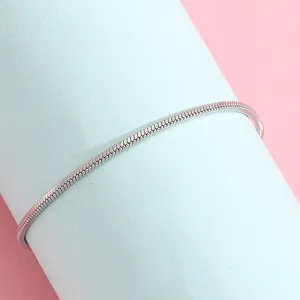 Detail of silver snake bone chain with metallic luster on blue display stand