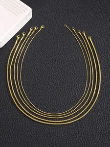 Detailed set of five gold plated stainless steel snake chains with lobster clasps on leather