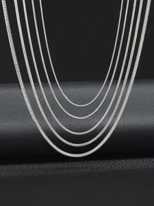 Detailed view of silver snake chains in six different thicknesses on black background