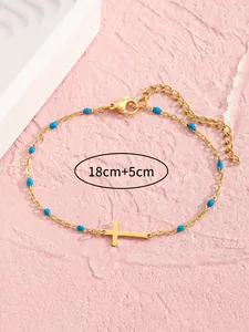 Detail einer 18+5cm goldenen Edelstahlkette mit blauen Perlen und einem Kreuzanhänger