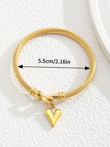 Detail showing inner diameter of 18K gold plated twisted cuff bracelet with heart charm