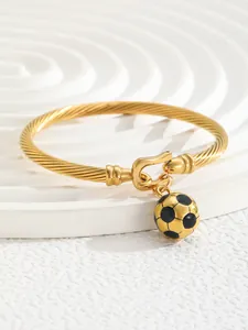 Detail of 18K gold plated twisted bangle with a black and gold soccer charm pendant