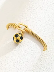 Detail of 18K gold-plated C-shaped twisted cuff bracelet with soccer ball pendant