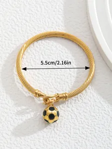 Detail of 18K gold plated C-shaped bangle with 5.5cm inner diameter and soccer charm