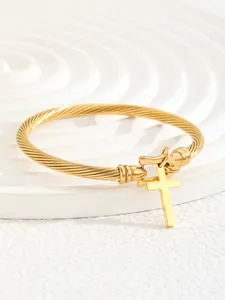 Close-up of 18K gold plated stainless steel cable bracelet with cross charm detail