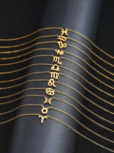 Détails de douze colliers avec signes du zodiaque dorés sur un présentoir noir étoilé