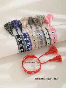 Close-up of bohemian woven Evil Eye bracelets with adjustable tassels in multiple colors