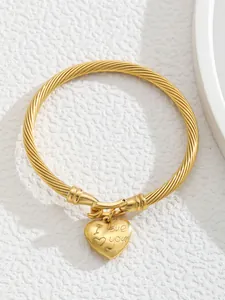 Detail view of 18K gold plated rope cuff bracelet featuring an engraved I Love You heart charm