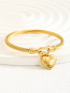 Close-up of 18K gold cable bracelet with engraved I Love You heart charm detail