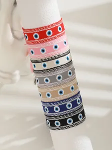 Detail of colorful woven Evil Eye bracelets with traditional embroidery and tassels