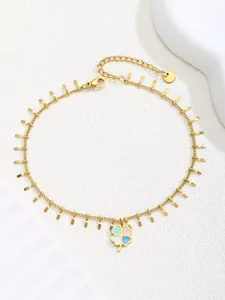 Detail of stainless steel gold anklet with colorful enamel clover and lobster clasp