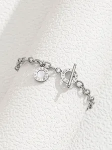 Macro shot of silver chain bracelet featuring a shell inlay pendant and OT toggle clasp