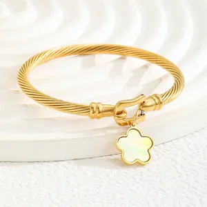 18K gold plated stainless steel cable cuff bracelet with a floral shell pendant