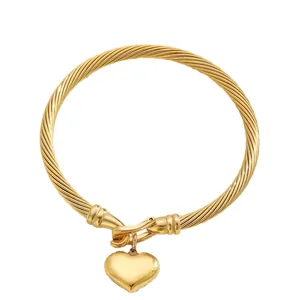 Polished 18K gold plated stainless steel twisted C-shaped cuff bangle with heart pendant