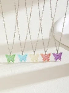 Detail showing five colorful butterfly pendant necklaces in mint, blue, pink, and lilac