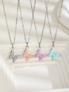 Detailed macro view of four butterfly pendant necklaces in soft macaron enamel colors