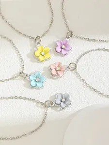 Macro detail of colorful five-petal flower pendants with sparkling center rhinestones