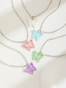 Detail of colorful butterfly necklaces in white, blue, pink, green, and purple shades