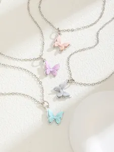 Detail of butterfly pendant necklaces in pink, purple, white and blue pastel colors