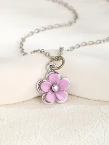 Macro detail of lavender flower pendant necklace with central cubic zirconia stone