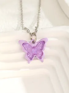 Detailed macro view of purple resin butterfly pendant with delicate silver metal chain