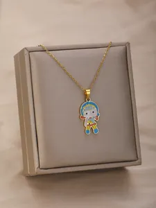 Detailed close-up of a gold necklace featuring a colorful cartoon girl doll pendant