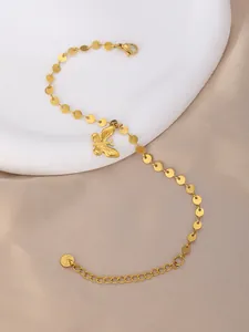 Detail of gold stainless steel bracelet featuring butterfly charm and lobster clasp