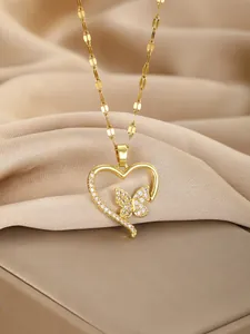 Detailed macro of gold heart butterfly pendant with white zircon micro-pave setting