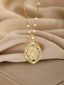 Detailed macro view of a gold Virgin Mary pendant with sparkling zircon borders